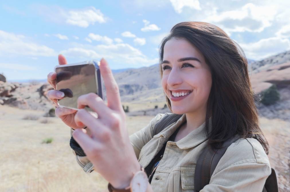 Lady holding her phone taking a picture