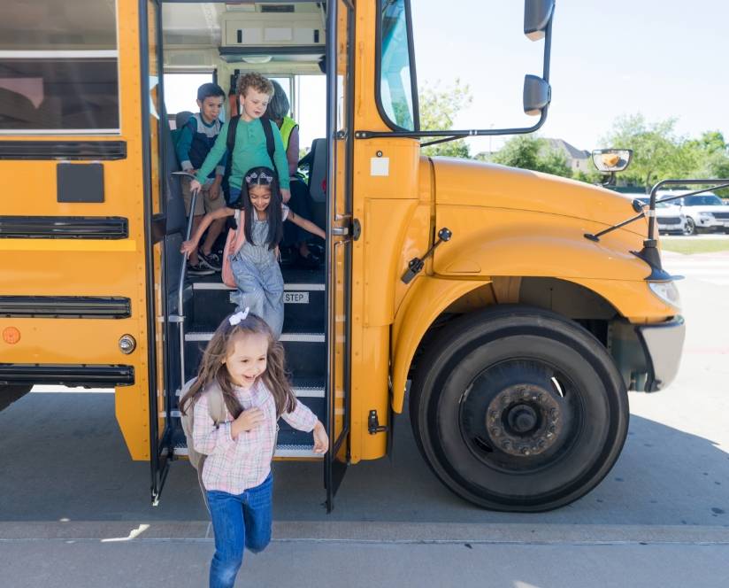 Kids coming out of a yellow school bus